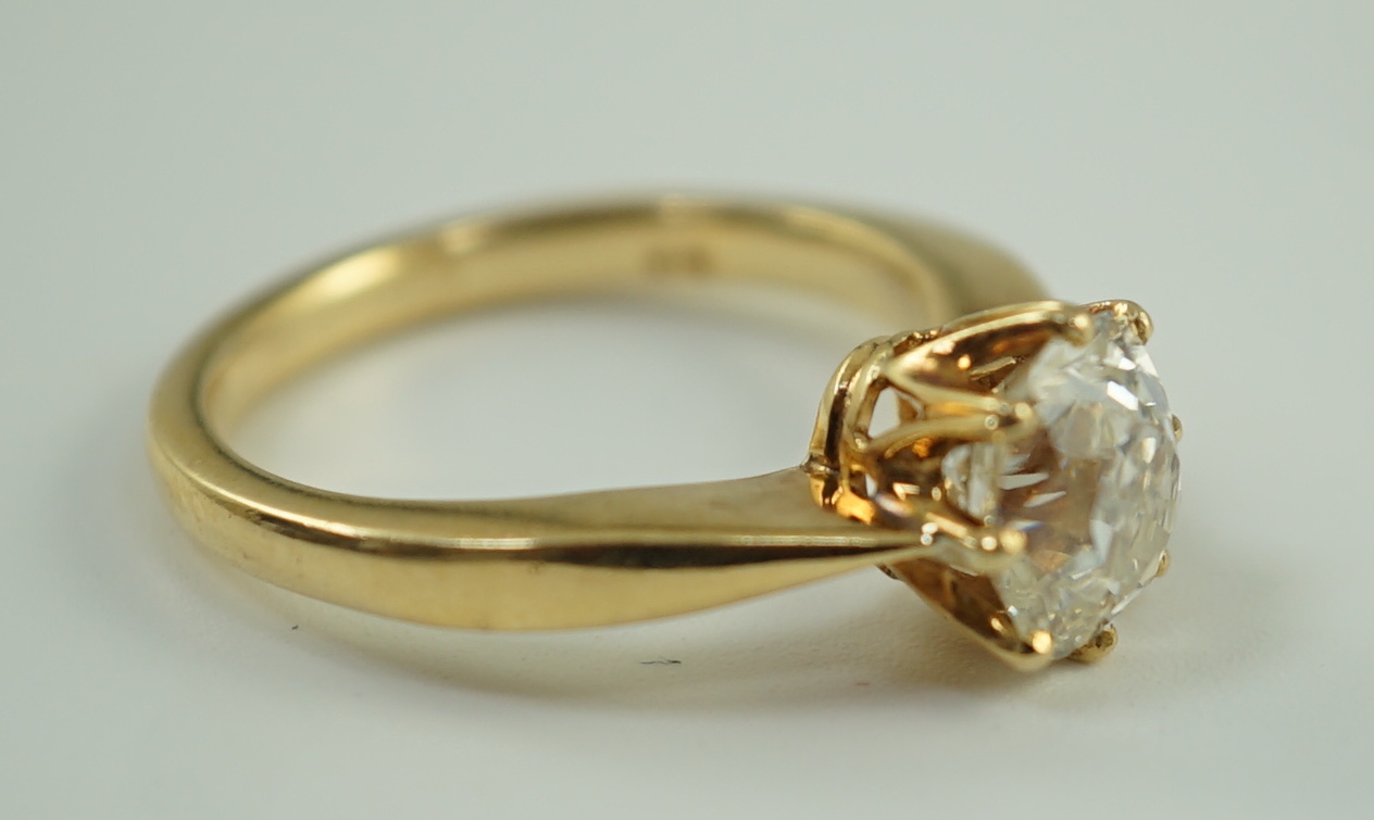 An 18k gold and oval cushion cut solitaire diamond ring